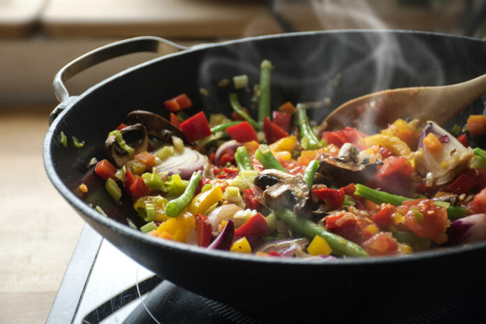 steaming mixed vegetables in the wok, asian style cooking vegetarian and healthy, selected focus, narrow depth of field