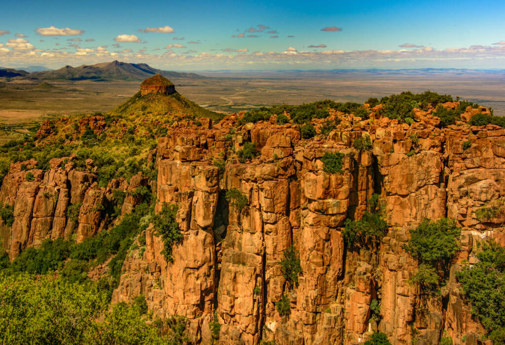 Sunny South Africa Graaff-Reinet,Valley of Desolation panorama,impressive bizarre rocks in golden light, mountains and endless landscape with blue sky and clouds, loneliness,vastness,scenic, panoramic
