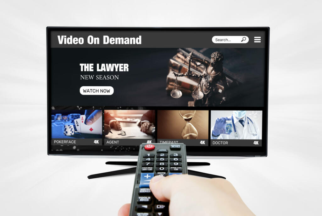 Video on demand, TV streaming, multimedia. Hand holding remote control