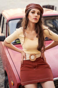 Young beautiful girl dressed in retro vintage style enjoying the summertime lifestyle of old european city