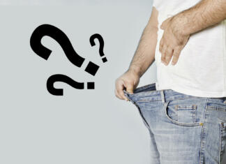 Spolne bolezni od A do Ž A man with erectile dysfunction looking into his jeans waiting for any reaction. Concept of mens sexual health, impotence. Man having erectile problems. A guy looking in his pants