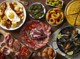 A table with typical Spanish food seen from above on a wooden table