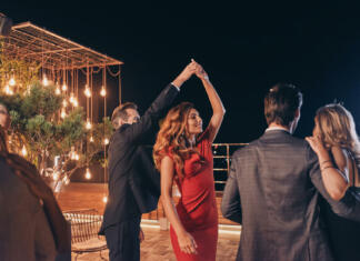 Standardni in latinskoameriški plesi Beautiful young people dancing and smiling while spending time on luxury party