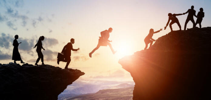 Challenge of business concept. Group of businesspeople climbing a mountain. Teamwork. Success.