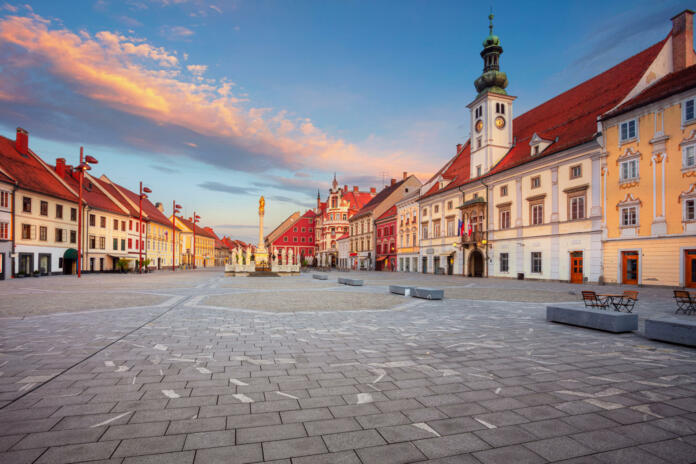 Cityscape image of Maribor, Slovenia with the Main Square and the Town Hall at summer sunrise.