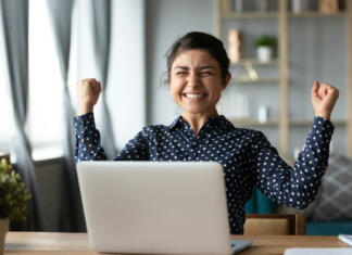 Si bil sprejet v 2. prijavnem roku? Euphoric young indian girl student winner celebrate victory triumph sit at home desk with laptop computer win online fortune feel excited get new job opportunity good exam result great news concept