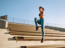 Fit Young woman in sportswear doing yoga, fitness exercise on the street. Warming up your muscles before an intense workout in the morning. Sport, Active life, sports training, healthy lifestyle.
