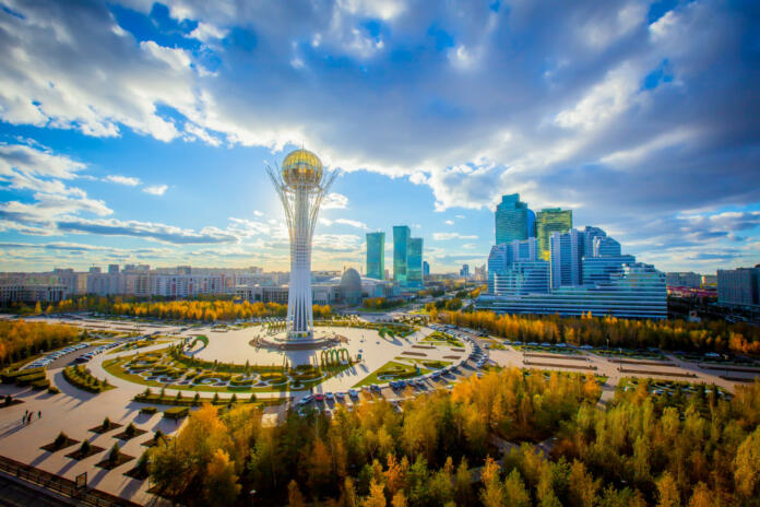 Golden autumn in the capital of Kazakhstan. Modern buildings and blue sky.
