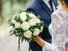 Happy bride and groom on their wedding hugging