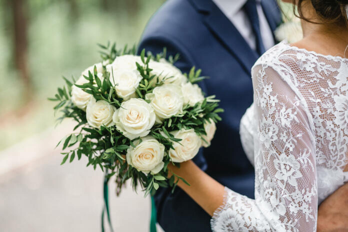 Happy bride and groom on their wedding hugging