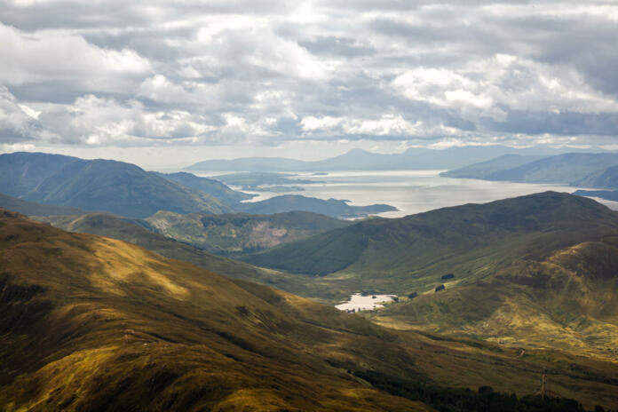 Hilly landscape with view on Loch Linhe from slopes of Ben Nevis, highest UK mountain, during the cloudy afternoon