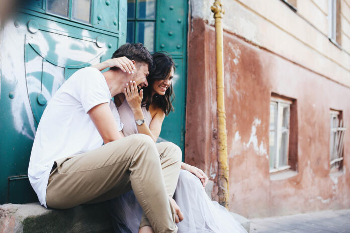 Beautiful,And,Young,Boy,And,Girl,Sits,Near,Green,Doors