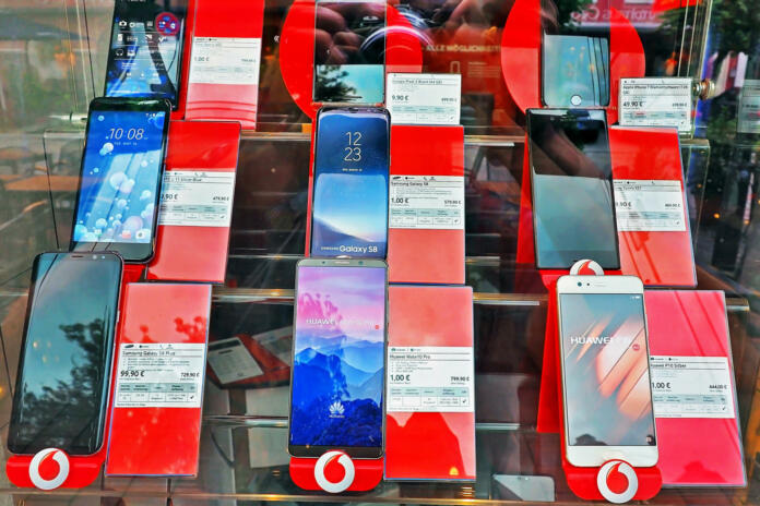 Munich Germany - 14 JUNE 2018: many Smartphone device prices at Vodafone shop displaying on the glass wall  in Munich City Germany