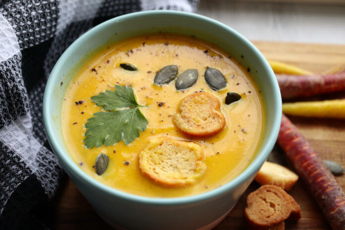 Pumpkin, sweet potato and carrot soup with pumpkin seeds, croutons pepper and parsley