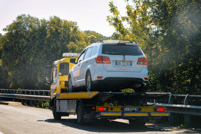 Rome, Italy - October 4, 2017: Tow truck with a car on the road