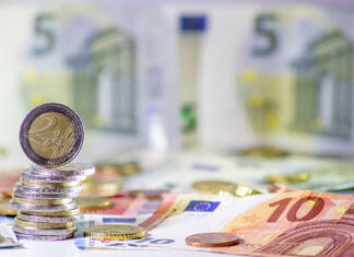 Vlada predlaga višanje povprečnin za občine Stack of european coins and bank notes in the background show international finance with euro and europe, european trade and financial trade as well as saving, financial success and credit management