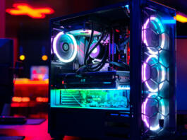 Top-end system unit for gaming computer close up. Inside of illuminated cybercafe. Concept of modern tech, fun, esport, online video games internet cafe