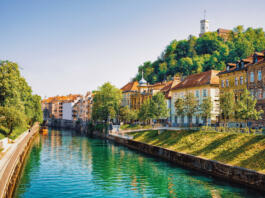 Waterfront of Ljubljanica River and Old castle on Castle hill in the historical center of Ljubljana, Slovenia