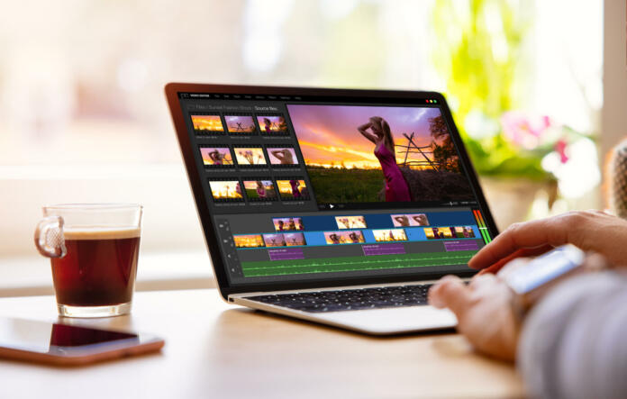 Woman editing video footage on laptop computer