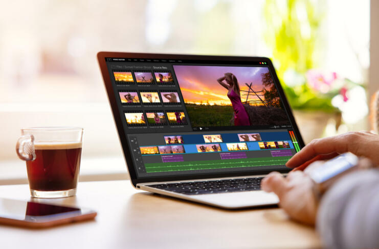 Woman editing video footage on laptop computer