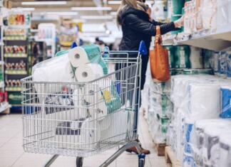 Se nam spet bliža wc papir kriza? Woman shopping at supermarket choosing toilet paper. The most important thing is to make a stock of toilet paper during pandemic.