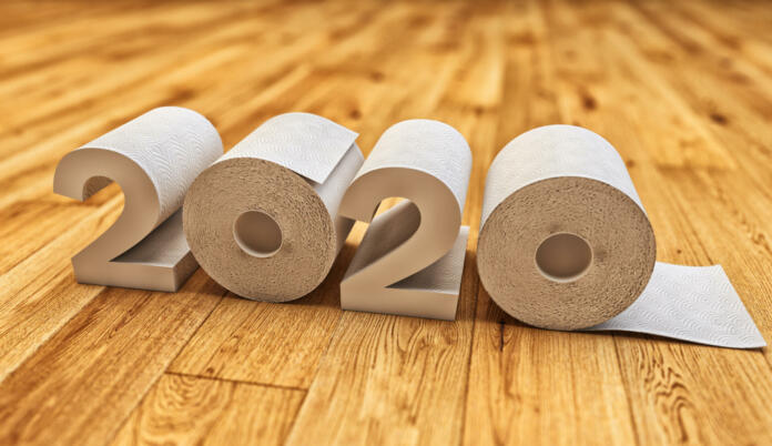 2020 symbol made from toilet paper rolls on wooden floor background