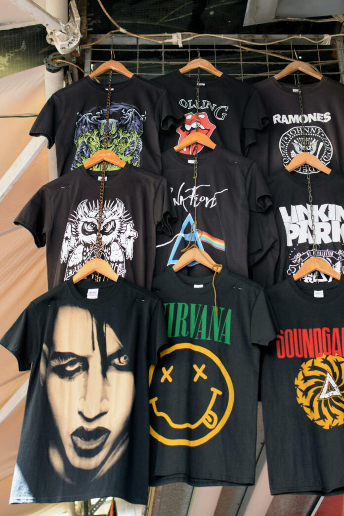 Athens, Greece - August 29, 2018: T-shirts printed with rock band designs. Pop music merchandise.