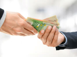 Businessman hands passing money, Euro currency (EUR), on white gray background