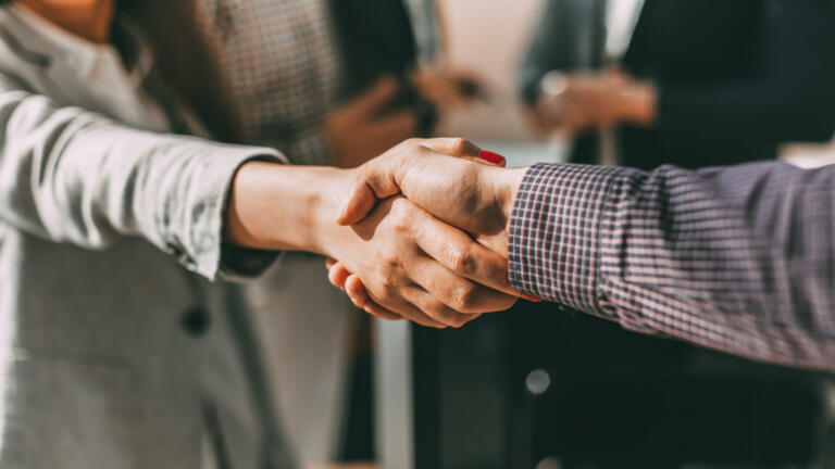 close up. young casual business people shaking hands with each other. business concept