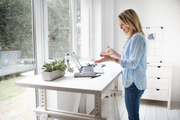 Ergonomic woman standing posture when using a computer