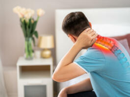Hernia of the cervical spine, neck pain, man suffering from ache in the bedroom, compression injury of the intervertebral disc, health problems concept