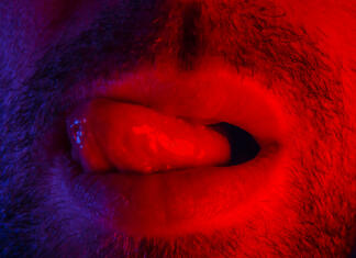 Največje napake pri oralnem zadovoljevanju žensk Macro close up on man with seductive facial expression sticking out his tongue licking his lips. Portrait of flirty young man looking at camera.