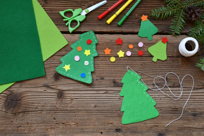 Making of handmade christmas tree from felt with your own hands. Children's DIY concept. Making xmas toys decoration or greeting card
