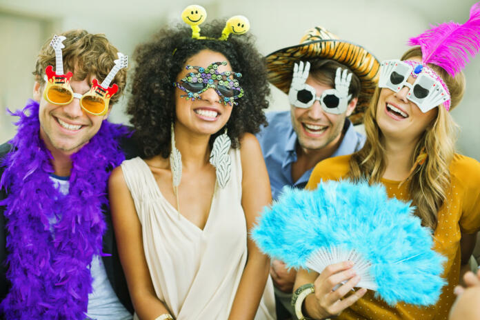 Smiling friends wearing silly glasses