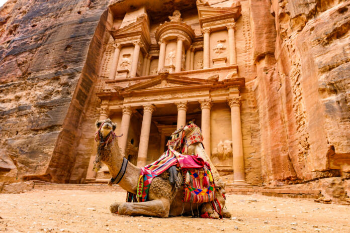 Spectacular view of two beautiful camels in front of Al Khazneh (The Treasury) in Petra. Petra is a historical and archaeological city in southern Jordan.