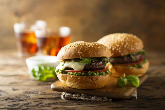 Traditional homemade beef burgers with pesto sauce