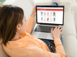 Young Woman Shopping On Laptop In Her Room
