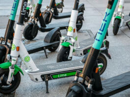 Berlin, Germany - June, 2019: Electric scooter , escooter or e-scooter of the ride sharing company LIME and TIER on sidewalk in Berlin, Germany