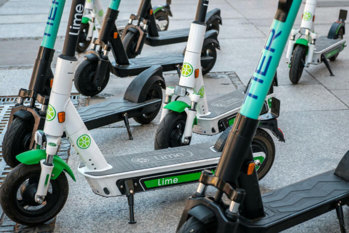 Berlin, Germany - June, 2019: Electric scooter , escooter or e-scooter of the ride sharing company LIME and TIER on sidewalk in Berlin, Germany