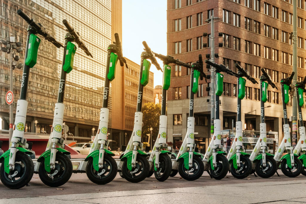 Berlin, Germany - October, 2019: Row of electric E scooters , escooter or e-scooter of the company LIME on sidewalk in Berlin