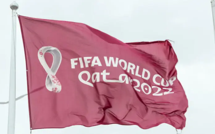doha-qatar-january-15th-2022-maroon-fifa-world-cup-qatar-2022-flag-flying-in-the-sky-above-doha-stockpack-istock Doha, Qatar - January 15th 2022: Maroon Fifa World Cup Qatar 2022 flag flying in the sky above Doha