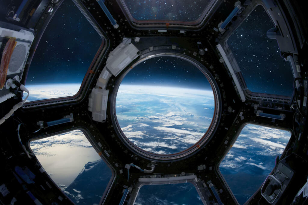 Earth planet view from ISS porthole. View from Cupola. International space station. Orbit and deep space with stars. Spaceship. Elements of this image furnished by NASA (url: https://www.nasa.gov/sites/default/files/styles/full_width_feature/public/thumbnails/image/iss043e284928.jpg https://www.nasa.gov/sites/default/files/styles/full_width_feature/public/thumbnails/image/iss063e074377.jpg)