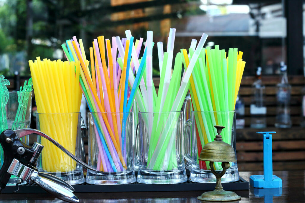 Many plastic drinking colorful straws in the restaurant bar.