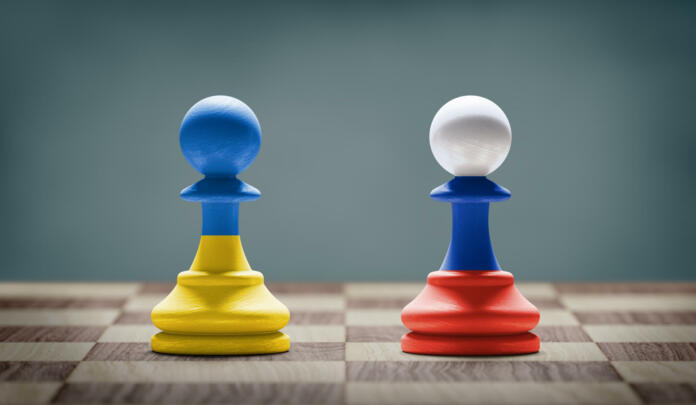 Ukraine and Russia conflict. Country flags on chess pawns on a chess board. 3D illustration.
