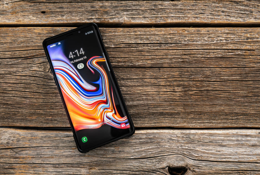 Ukraine, Uzhgorod - February, 14, 2019: Studio shot of Samsung Galaxy Note 9 smartphone on a wooden background, developed and marketed by Samsung Electronics.