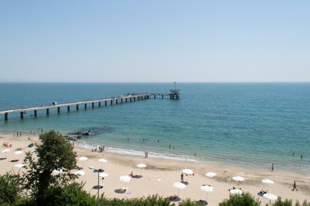 Peščena plaža in dolg lesen pomol