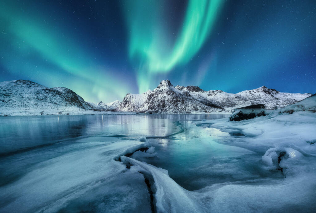 Aurora Borealis, Lofoten islands, Norway. Mountains and frozen ocean. Winter landscape in the night time. Northen light - image