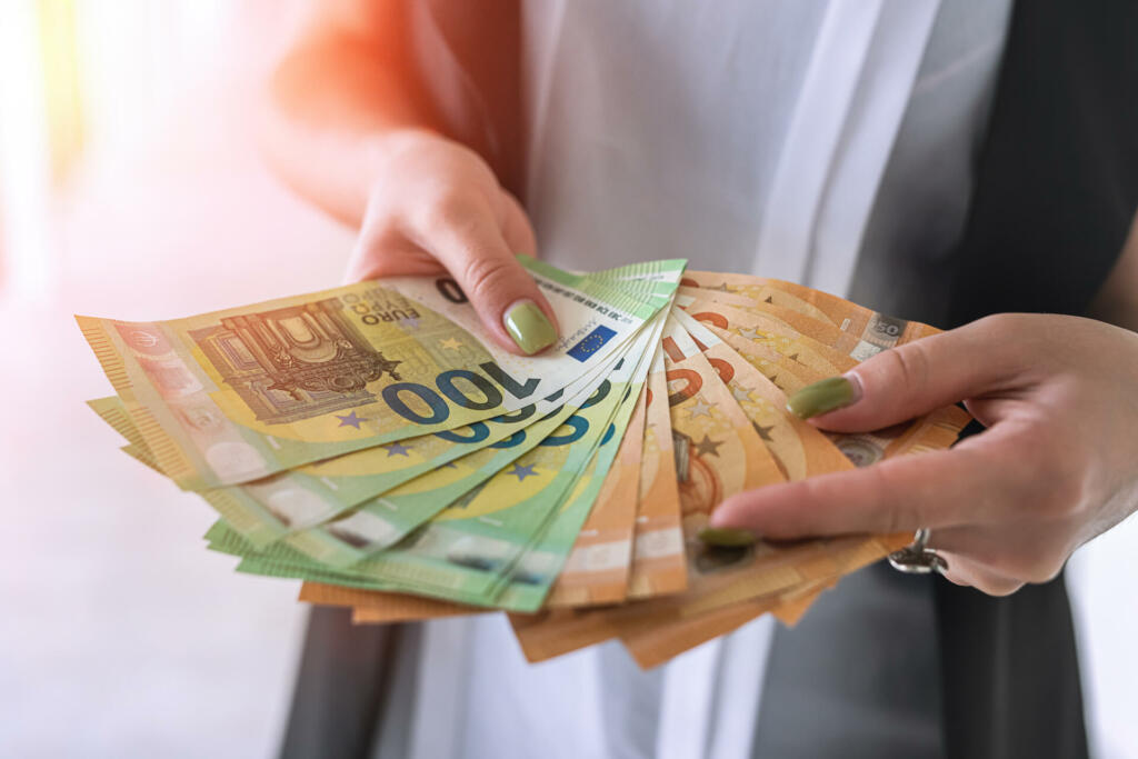 Businesswoman hands hold euro banknotes. finance concept