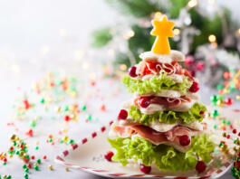Christmas tree from toasted bread, lettuce, ham and cheese. Festive idea for Christmas or New Year dinner.