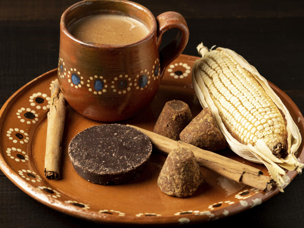 Corn drink with chocolate and cinnamon, champurrado, traditional Mexican cuisine.